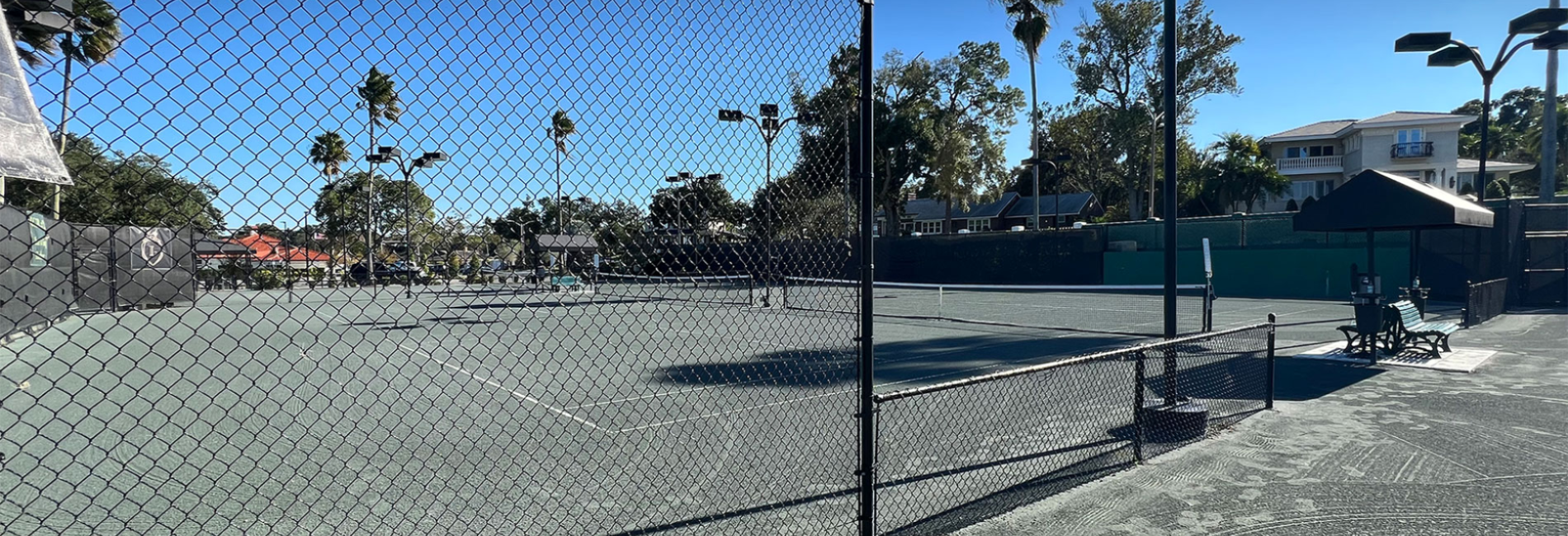 black round fence in use at a tennis court