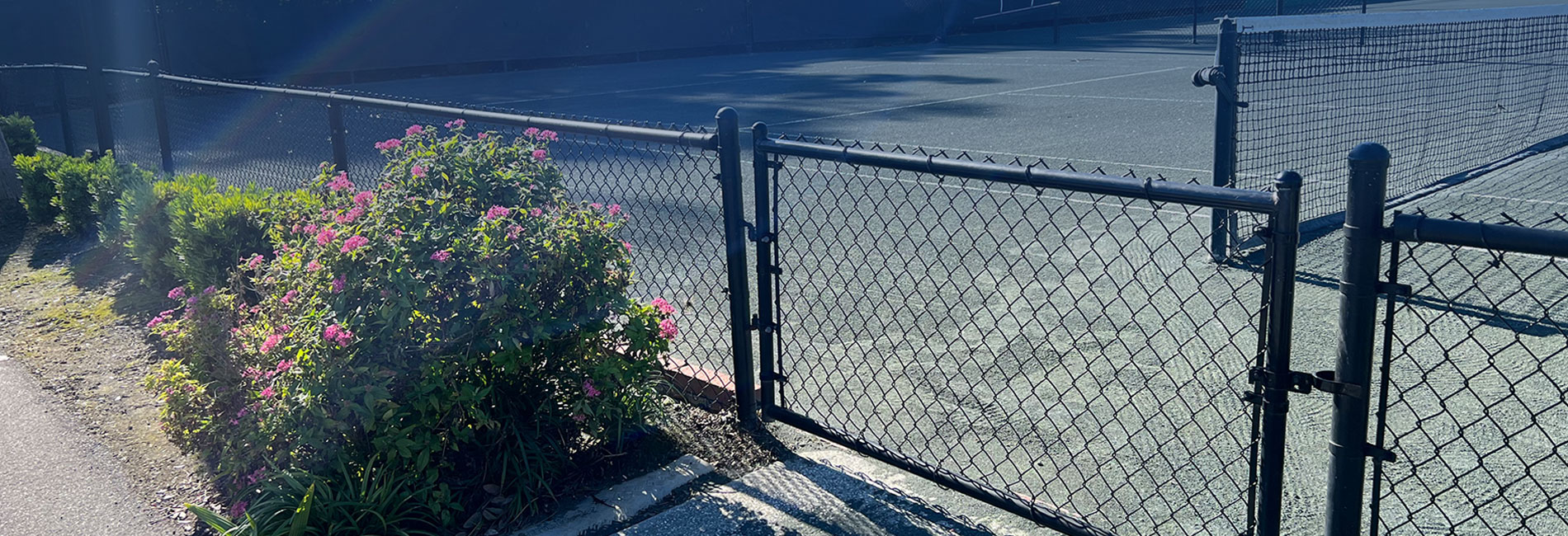 Black color coated tube with chain link fence in use on a tennis court
