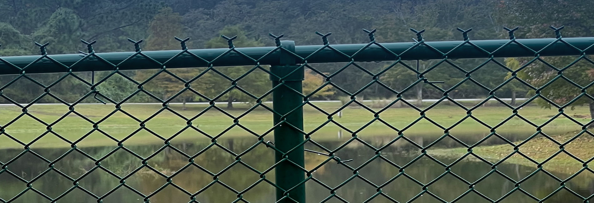 Green color coated tube with chain link fence slider image